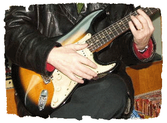 A customer playing a vintage sunburst guitar